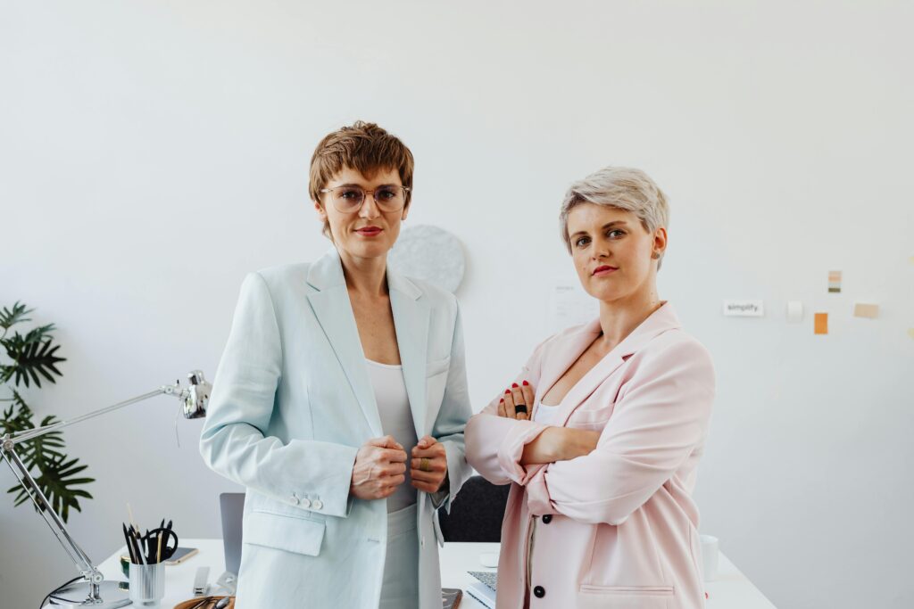 Women in Business Attires Posing Inside an Office